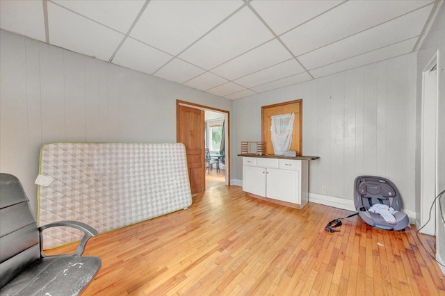 302 S Leney St, Ogden, IL 61859 - sitting room featuring a paneled ceiling, light wood-style flooring, and wooden walls