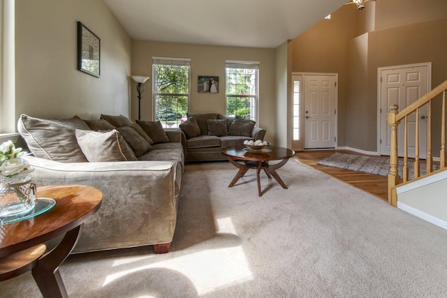 8307 Newbridge Ct, Joliet, IL 60431 - carpeted living area featuring stairs, vaulted ceiling, and wood finished floors
