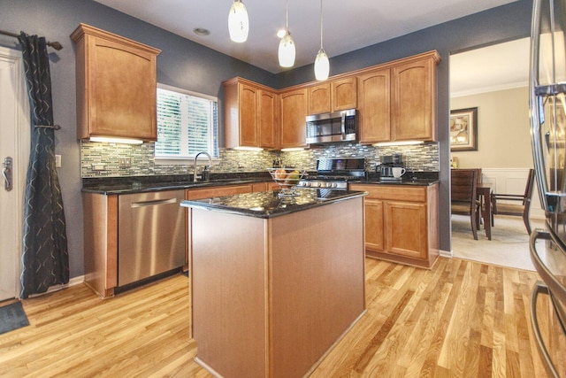 8307 Newbridge Ct, Joliet, IL 60431 - kitchen with stainless steel appliances, light wood-type flooring, a center island, hanging light fixtures, and tasteful backsplash