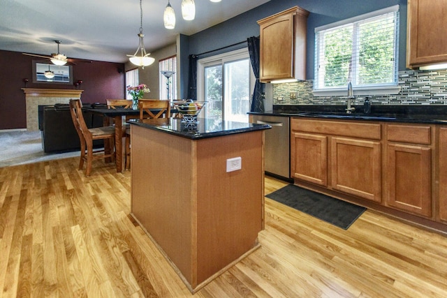 8307 Newbridge Ct, Joliet, IL 60431 - kitchen featuring stainless steel dishwasher, light wood-style floors, a kitchen island, and plenty of natural light