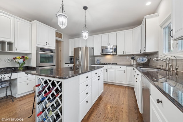25397 N Northbridge Rd, Hawthorn Woods, IL 60047 - kitchen with appliances with stainless steel finishes, light wood finished floors, white cabinets, a center island, and recessed lighting