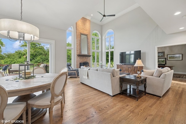 25397 N Northbridge Rd, Hawthorn Woods, IL 60047 - living room with a towering ceiling, ornamental molding, light wood finished floors, a brick fireplace, and a chandelier