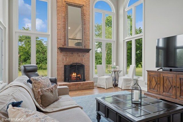 25397 N Northbridge Rd, Hawthorn Woods, IL 60047 - living room featuring a towering ceiling, a brick fireplace, and wood finished floors