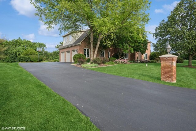 25397 N Northbridge Rd, Hawthorn Woods, IL 60047 - view of front facade with driveway, an attached garage, and a front yard
