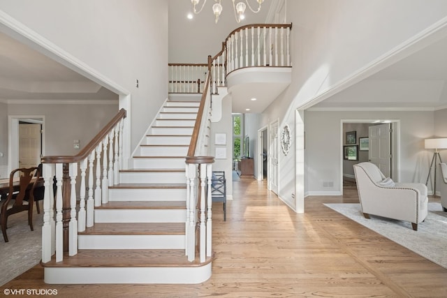 25397 N Northbridge Rd, Hawthorn Woods, IL 60047 - staircase featuring a towering ceiling, wood finished floors, a chandelier, and crown molding