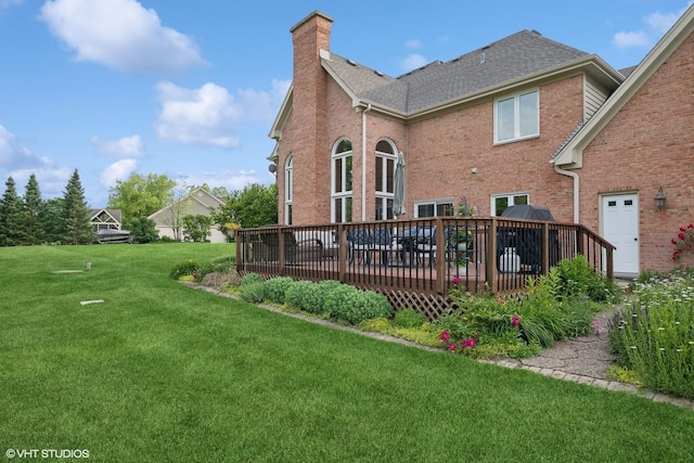 25397 N Northbridge Rd, Hawthorn Woods, IL 60047 - back of house featuring a chimney, a lawn, a wooden deck, brick siding, and roof with shingles