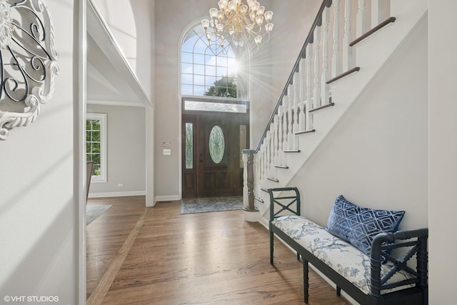 25397 N Northbridge Rd, Hawthorn Woods, IL 60047 - foyer featuring wood finished floors, a chandelier, stairway, and a towering ceiling