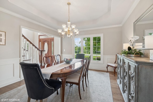 25397 N Northbridge Rd, Hawthorn Woods, IL 60047 - dining room featuring a wainscoted wall, light wood-style floors, a chandelier, a raised ceiling, and stairway