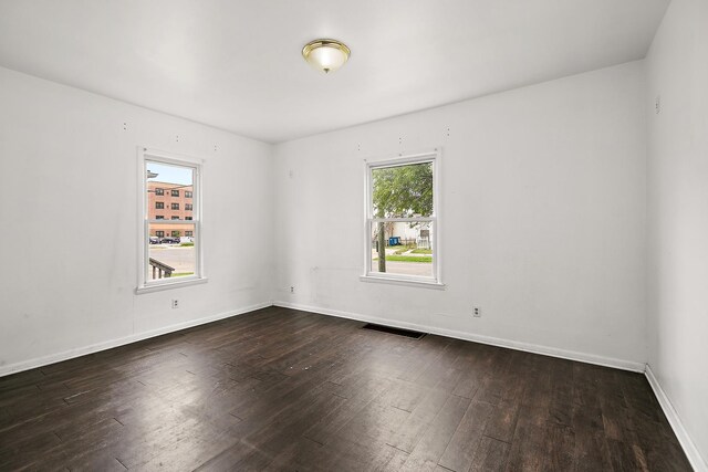 554 W Station St, Kankakee, IL 60901 - unfurnished room with dark wood-style floors and baseboards