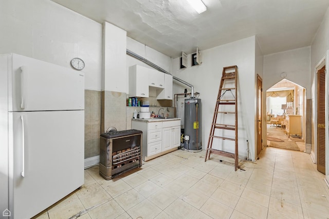 1448 W Taylor St, Chicago, IL 60607 - kitchen featuring freestanding refrigerator, water heater, light countertops, and white cabinetry