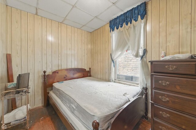 1448 W Taylor St, Chicago, IL 60607 - bedroom with a drop ceiling, dark wood-style flooring, and wood walls