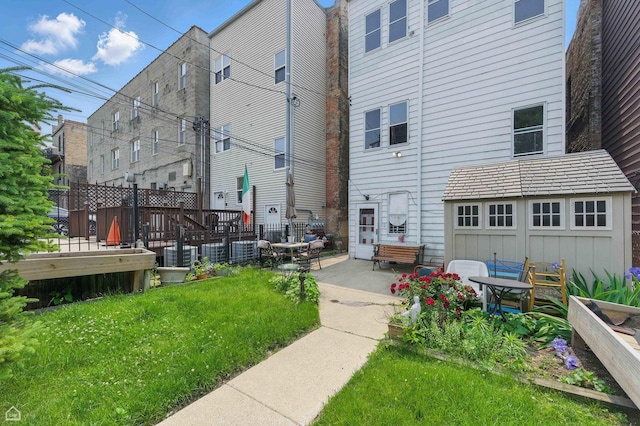 1448 W Taylor St, Chicago, IL 60607 - back of house with board and batten siding and a patio area