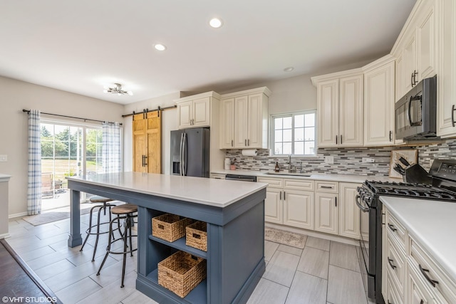 253 Brookhaven Trl, Pingree Grove, IL 60140 - kitchen with range with gas stovetop, black microwave, stainless steel refrigerator with ice dispenser, a kitchen bar, and light countertops