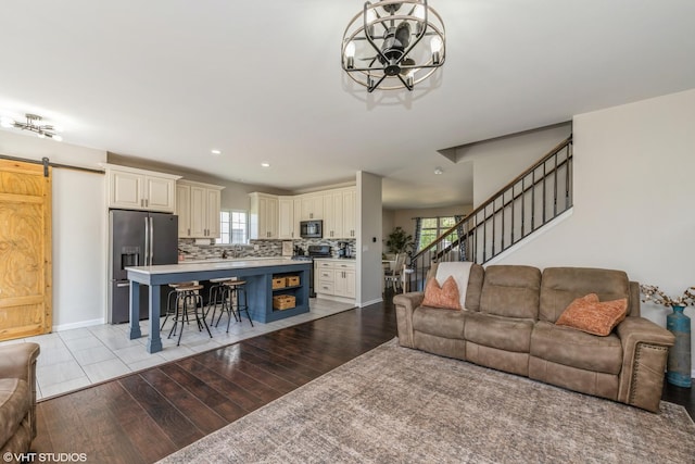253 Brookhaven Trl, Pingree Grove, IL 60140 - living room with a barn door, a chandelier, healthy amount of natural light, stairs, and recessed lighting
