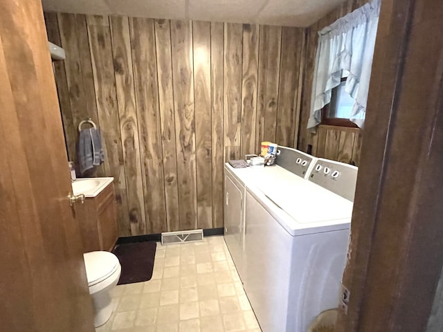 1660 Laharpe St, Lasalle, IL 61301 - laundry room with washing machine and clothes dryer and wooden walls