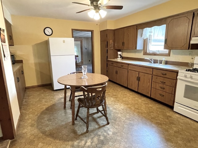 1660 Laharpe St, Lasalle, IL 61301 - kitchen with white appliances, tile countertops, a ceiling fan, extractor fan, and brown cabinetry