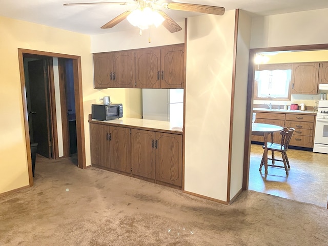 1660 Laharpe St, Lasalle, IL 61301 - kitchen featuring white appliances, ceiling fan, ventilation hood, light countertops, and light colored carpet