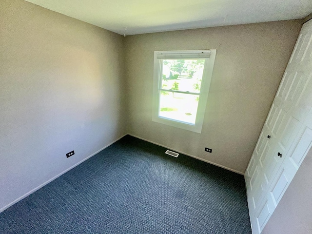 1015 Hastings Ln, Hanover Park, IL 60133 - unfurnished bedroom with dark colored carpet and baseboards