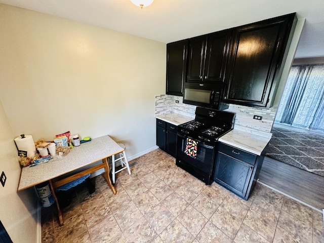 1015 Hastings Ln, Hanover Park, IL 60133 - kitchen with dark cabinetry, black appliances, backsplash, and light countertops