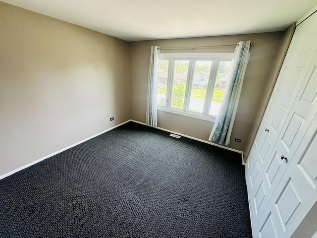 1015 Hastings Ln, Hanover Park, IL 60133 - unfurnished room featuring baseboards and dark carpet