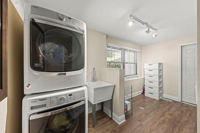 440 Menominee Ln, Naperville, IL 60563 - laundry room with stacked washing machine and dryer, dark wood-type flooring, and track lighting
