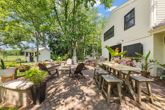 440 Menominee Ln, Naperville, IL 60563 - view of patio with an outdoor fire pit, outdoor dining area, and an outbuilding