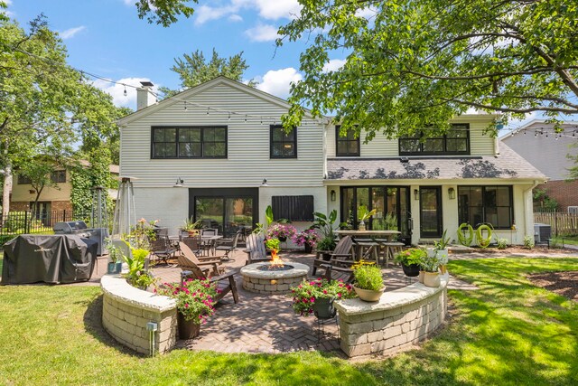 440 Menominee Ln, Naperville, IL 60563 - rear view of property featuring a fire pit, a patio, a chimney, and brick siding
