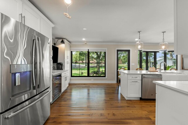 440 Menominee Ln, Naperville, IL 60563 - kitchen with appliances with stainless steel finishes, wine cooler, white cabinetry, crown molding, and dark wood finished floors