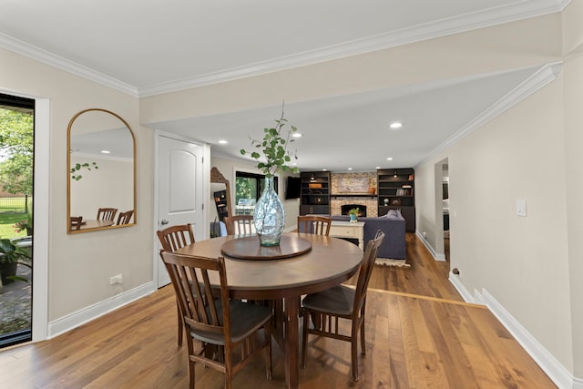 440 Menominee Ln, Naperville, IL 60563 - dining room with light wood finished floors, ornamental molding, a fireplace, and recessed lighting