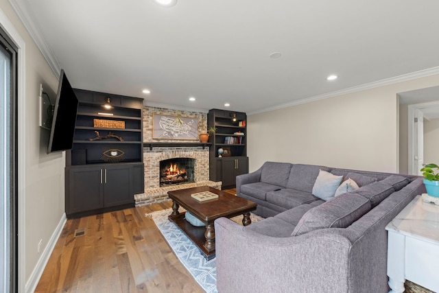 440 Menominee Ln, Naperville, IL 60563 - living room featuring light wood-style floors, ornamental molding, a brick fireplace, recessed lighting, and built in features