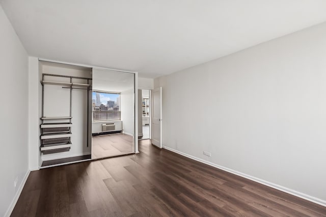 1460 N Sandburg Ter Unit 2703, Chicago, IL 60610 - unfurnished bedroom featuring dark wood-style flooring, a closet, and a wall mounted AC