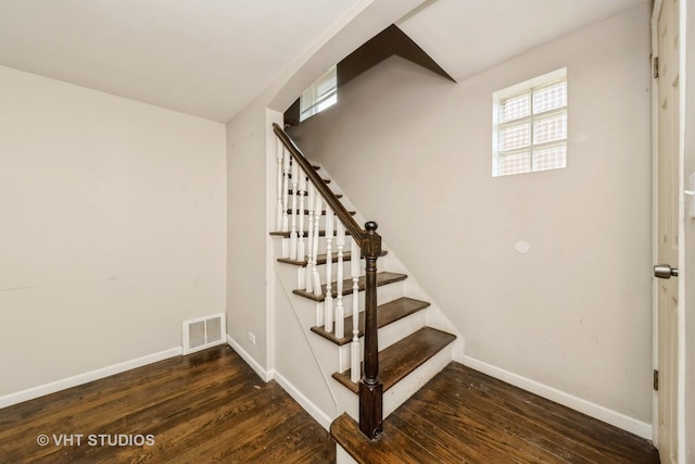 stairway with wood finished floors