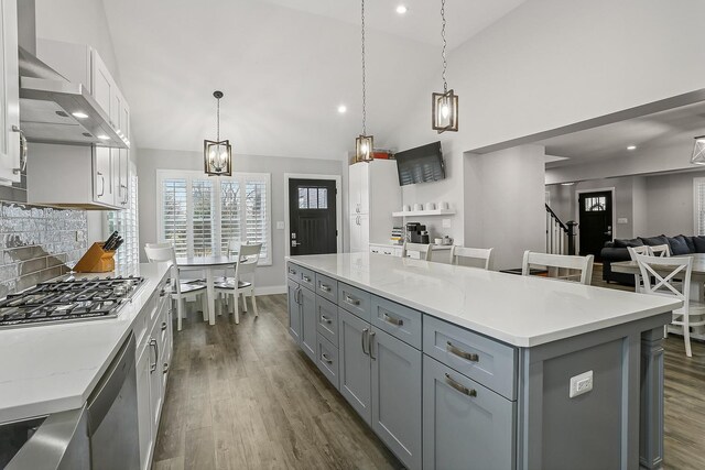 8081 Tennessee Ave, Willowbrook, IL 60527 - kitchen with gray cabinetry, wall chimney range hood, dark wood-style flooring, recessed lighting, and high vaulted ceiling