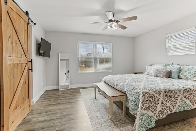 8081 Tennessee Ave, Willowbrook, IL 60527 - bedroom with a barn door, wood finished floors, and a ceiling fan