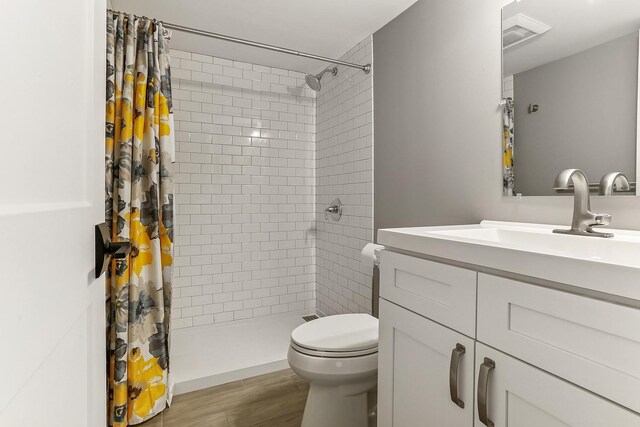 8081 Tennessee Ave, Willowbrook, IL 60527 - bathroom featuring vanity, a tile shower, and wood finished floors