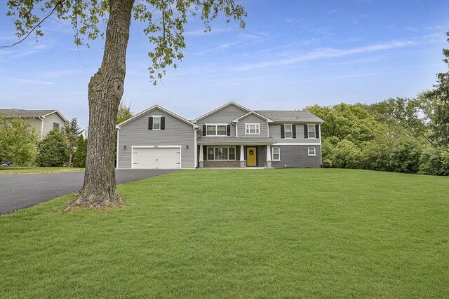 8081 Tennessee Ave, Willowbrook, IL 60527 - view of front of home with driveway, a front lawn, covered porch, and a garage