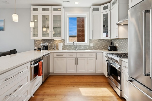2442 N Clybourn Ave Unit 5S, Chicago, IL 60614 - kitchen featuring high end appliances, decorative backsplash, white cabinetry, and recessed lighting