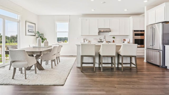 1818 Legacy Pointe Blvd, Plainfield, IL 60586 - kitchen with stainless steel appliances, recessed lighting, an island with sink, white cabinets, and dark wood-type flooring