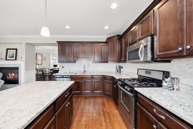 17946 Fountain Cir, Orland Park, IL 60467 - kitchen featuring stainless steel appliances, crown molding, light stone counters, dark brown cabinetry, and backsplash