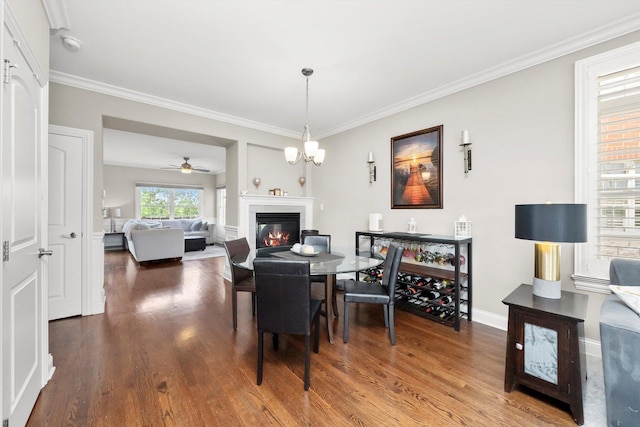 17946 Fountain Cir, Orland Park, IL 60467 - dining room with wood finished floors, a glass covered fireplace, and ornamental molding