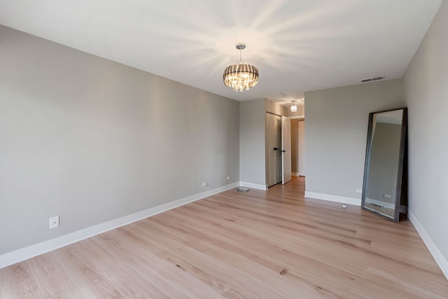 1250 Rudolph Rd Unit 4N, Northbrook, IL 60062 - spare room with a chandelier and light wood finished floors