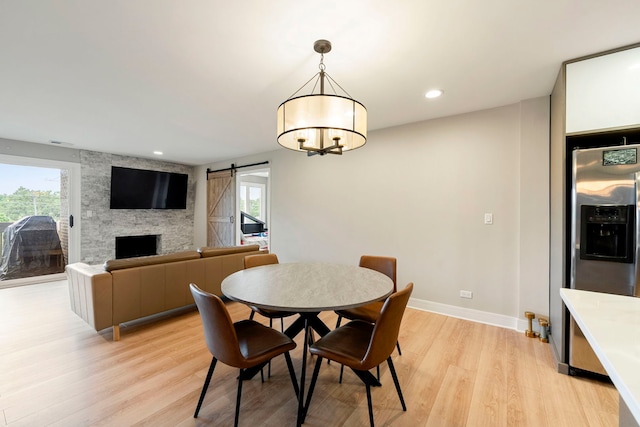 1250 Rudolph Rd Unit 4N, Northbrook, IL 60062 - dining area with a barn door, healthy amount of natural light, light wood-style floors, a chandelier, and recessed lighting