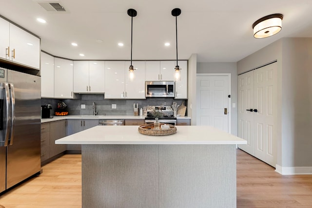 1250 Rudolph Rd Unit 4N, Northbrook, IL 60062 - kitchen featuring stainless steel appliances, light wood finished floors, backsplash, light countertops, and recessed lighting