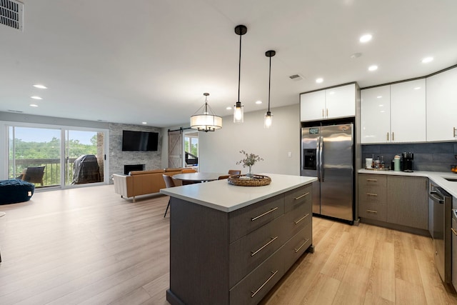 1250 Rudolph Rd Unit 4N, Northbrook, IL 60062 - kitchen featuring stainless steel appliances, light wood-style flooring, white cabinetry, light countertops, and recessed lighting