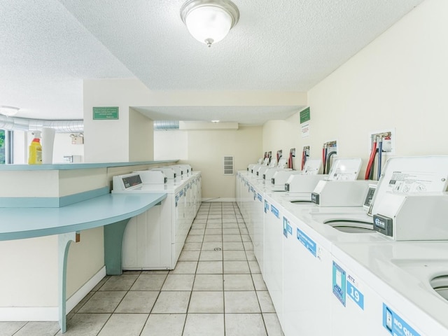 2754 N Hampden Ct Unit 1003, Chicago, IL 60614 - communal laundry room with separate washer and dryer, a textured ceiling, and light tile patterned flooring
