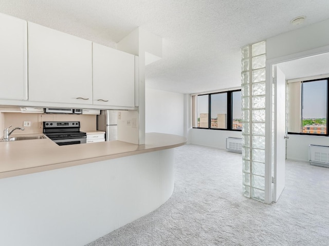 2754 N Hampden Ct Unit 1003, Chicago, IL 60614 - kitchen featuring electric range, freestanding refrigerator, light colored carpet, light countertops, and white cabinets