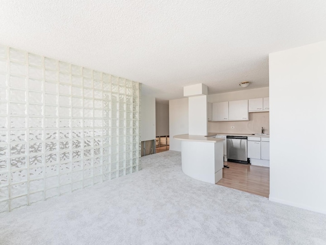 2754 N Hampden Ct Unit 1003, Chicago, IL 60614 - kitchen with dishwasher, light colored carpet, white cabinetry, light countertops, and a textured ceiling