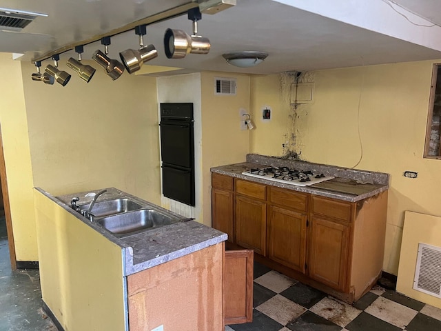 8144 S Ada St, Chicago, IL 60620 - kitchen featuring brown cabinetry, white gas cooktop, tile patterned floors, and a kitchen island