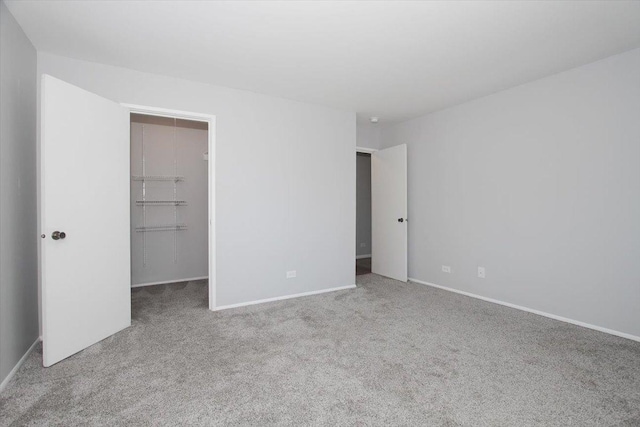 974 Thornton Ln Unit 107, Buffalo Grove, IL 60089 - unfurnished bedroom featuring a walk in closet, carpet, and a closet