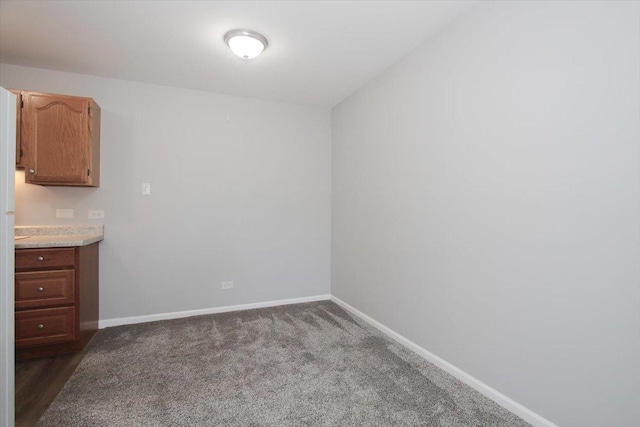 974 Thornton Ln Unit 107, Buffalo Grove, IL 60089 - unfurnished dining area featuring baseboards and dark carpet